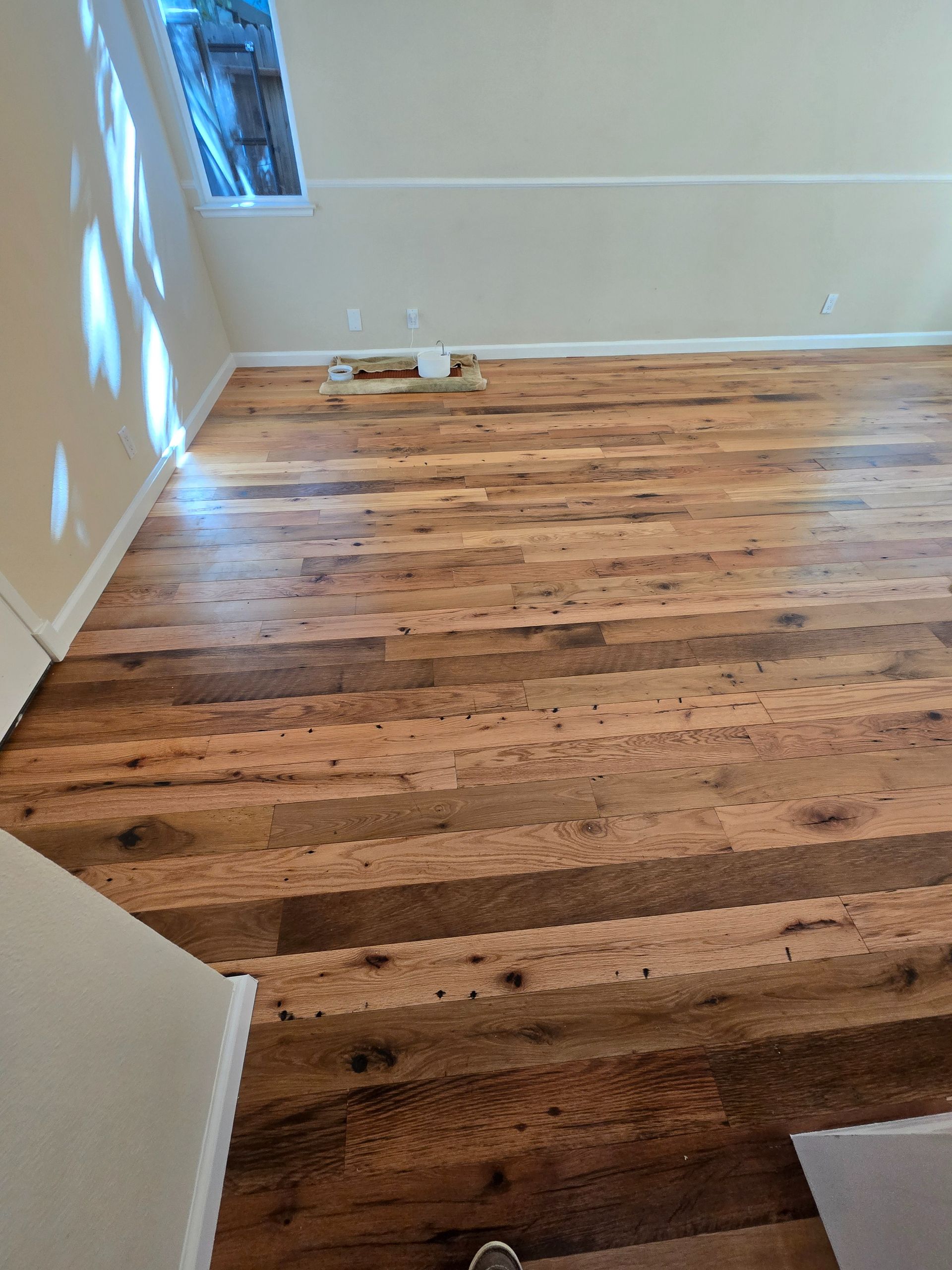 Transformed Davis, CA home by replacing dated Saltillo tile with beautiful, eco-friendly reclaimed hardwood floors.