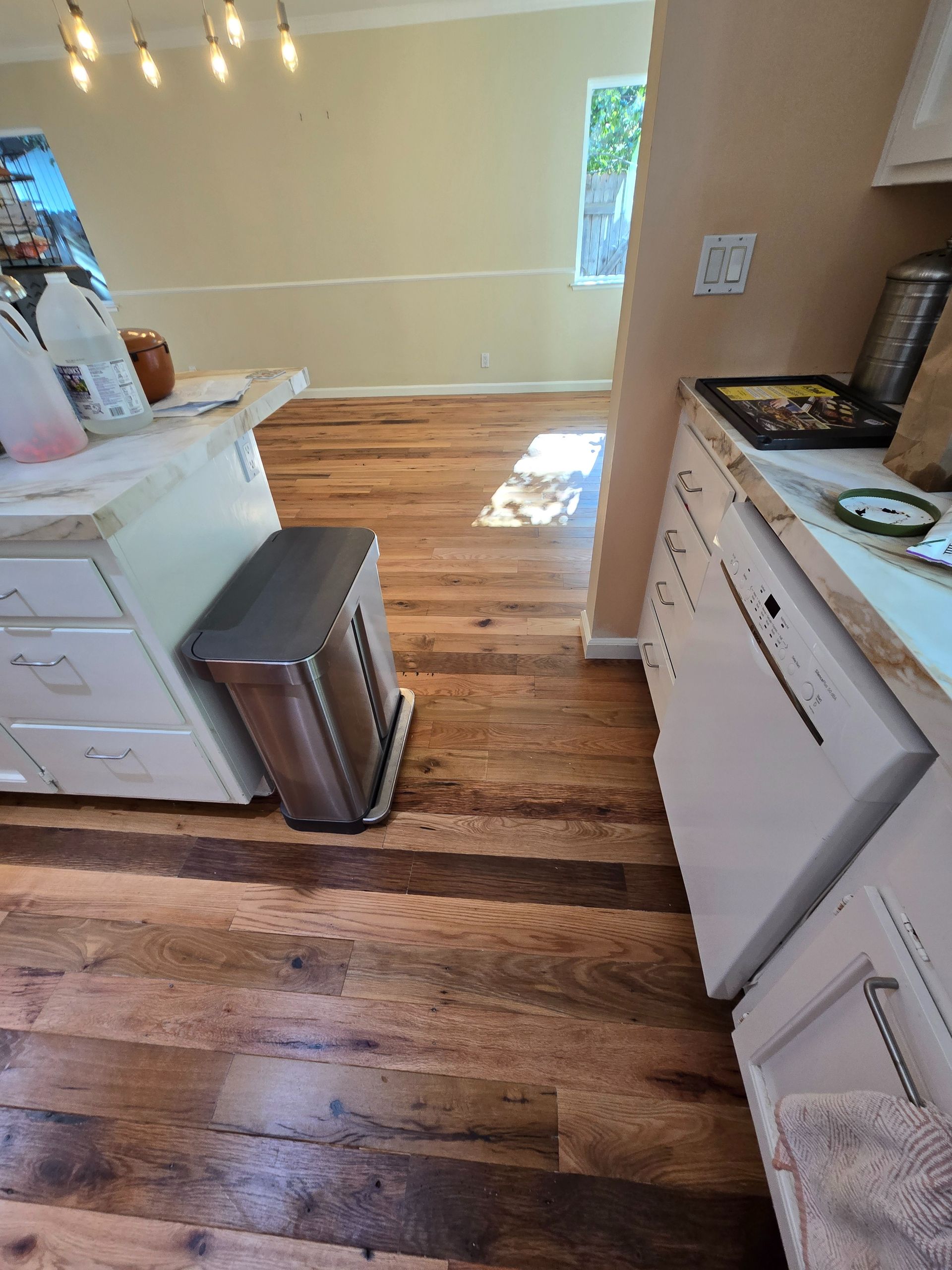 Transformed Davis, CA home by replacing dated Saltillo tile with beautiful, eco-friendly reclaimed hardwood floors.