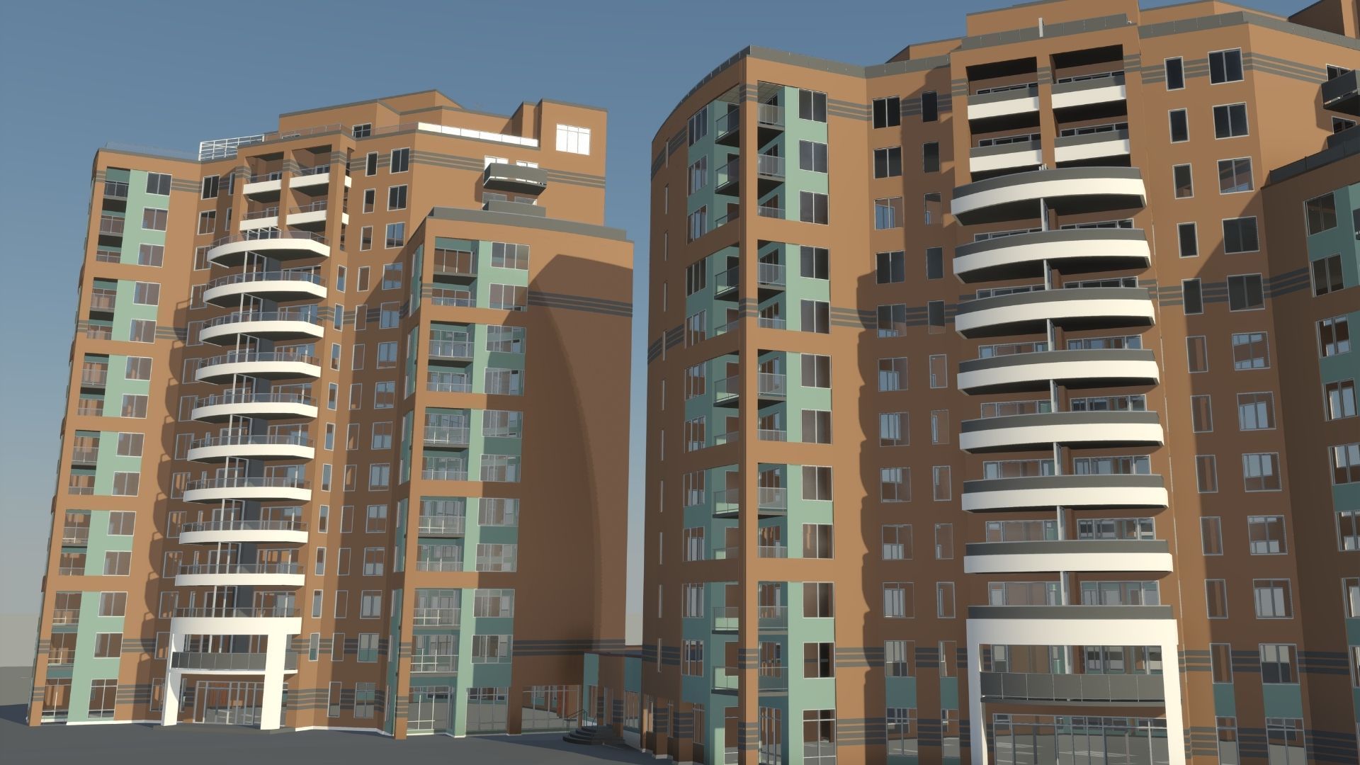 Two brick apartment towers with curved balconies on a street under a clear sky.