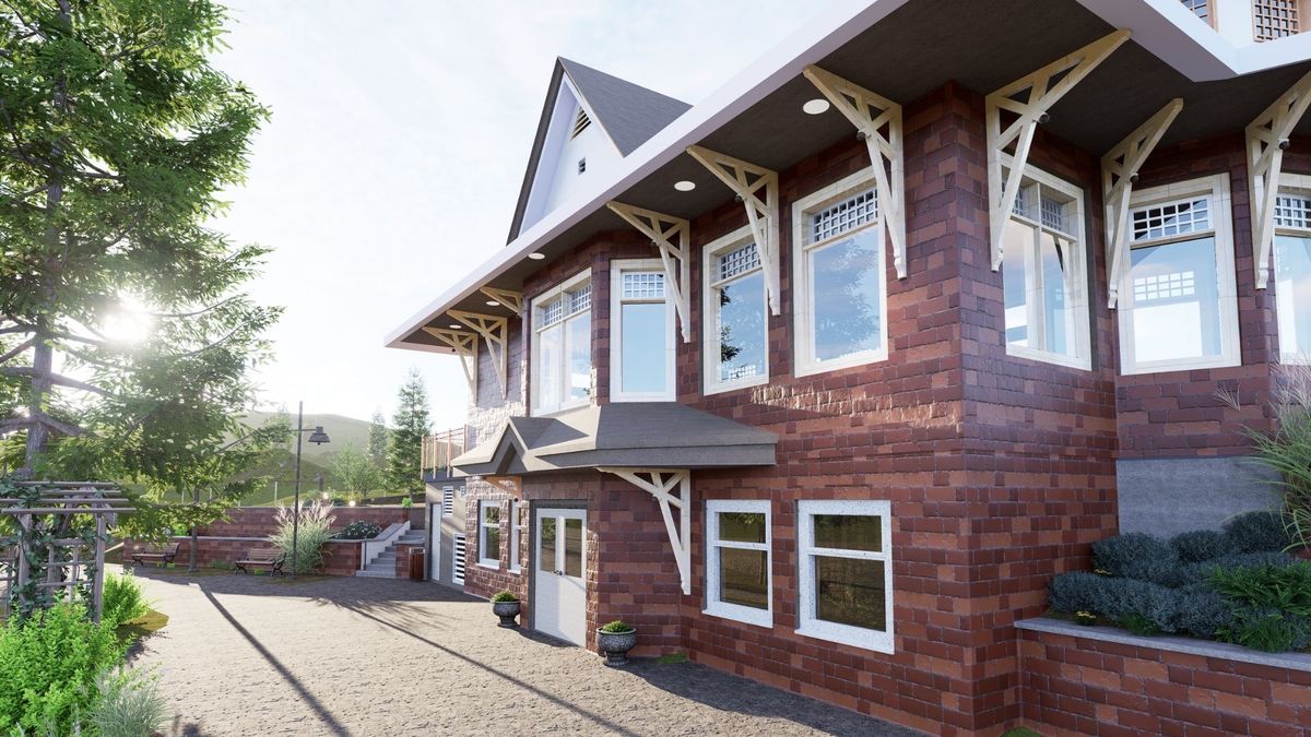Brick house with white-trimmed windows and a gravel driveway in bright sunlight