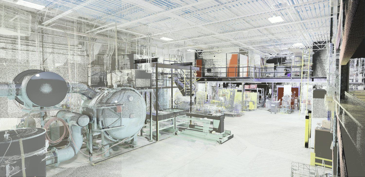 Bright industrial workshop with large machinery, metal framework, and bright overhead lighting