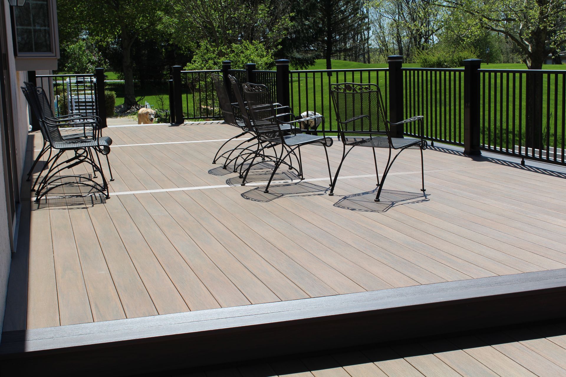 A wooden deck with chairs and a table on it