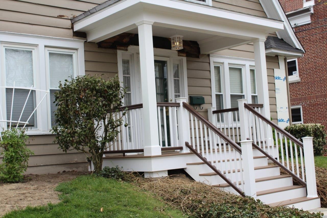 A house with a porch and stairs leading up to it