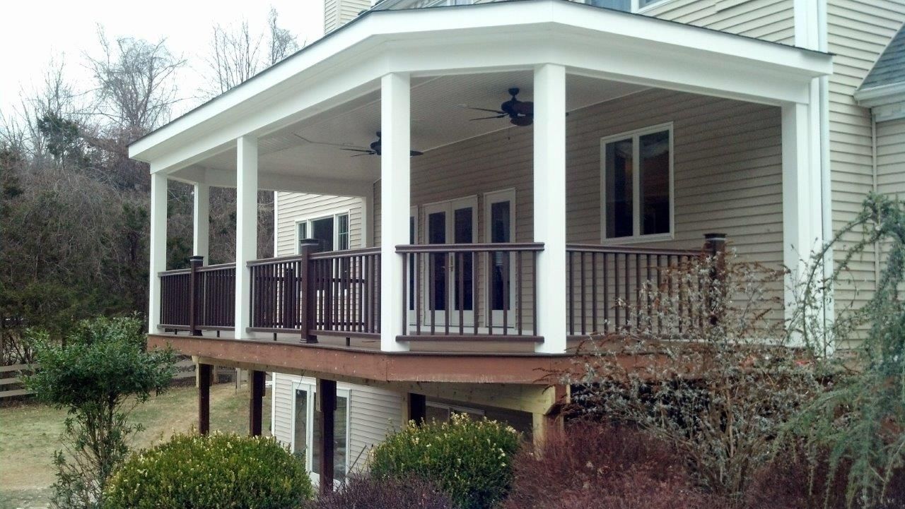 A house with a large porch and a ceiling fan