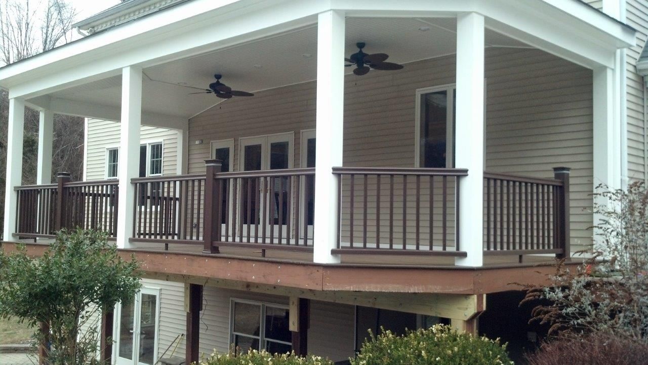 A house with a large porch and a ceiling fan.