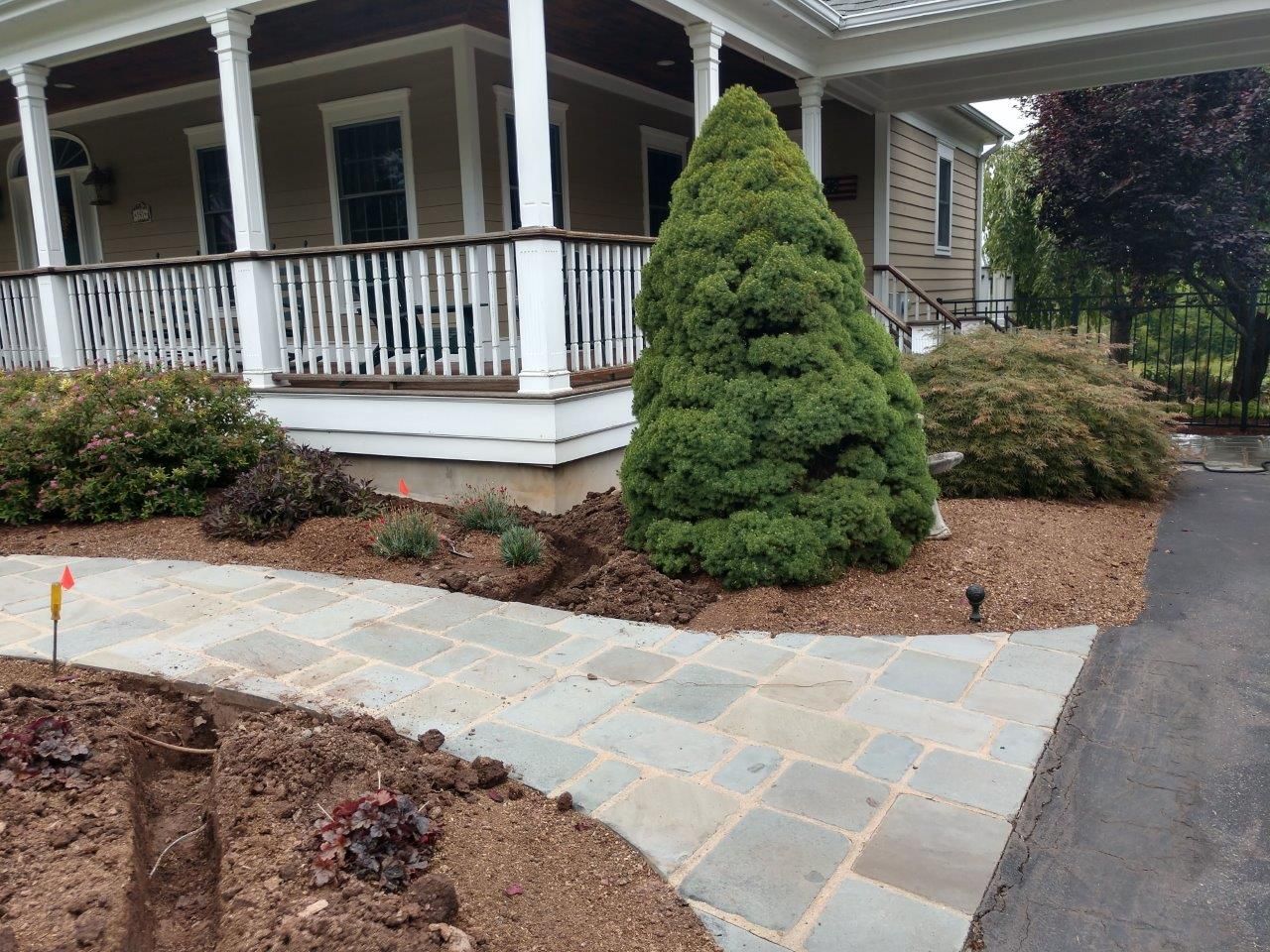 A house with a porch and a walkway leading to it