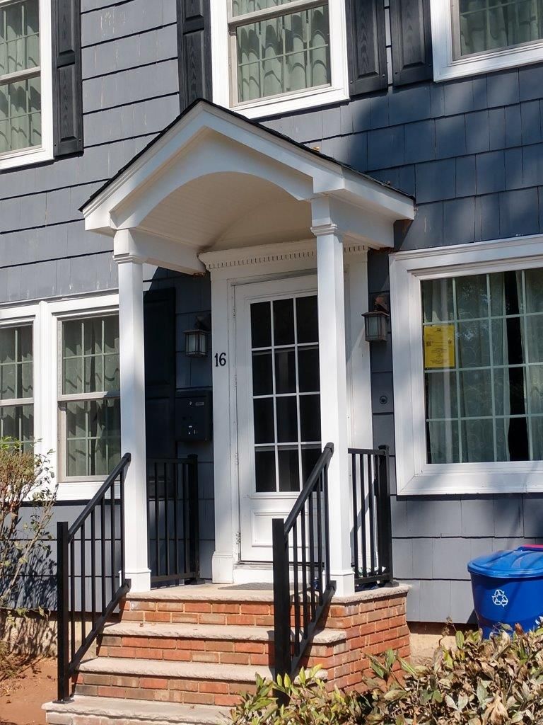 A house with the number 16 on the front door