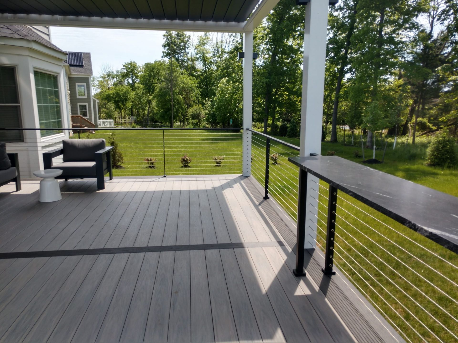 A deck with a chair and a table on it