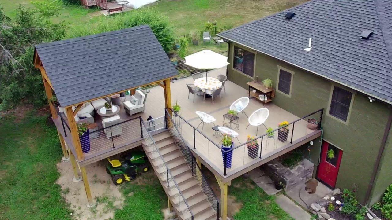 An aerial view of a house with a large deck.