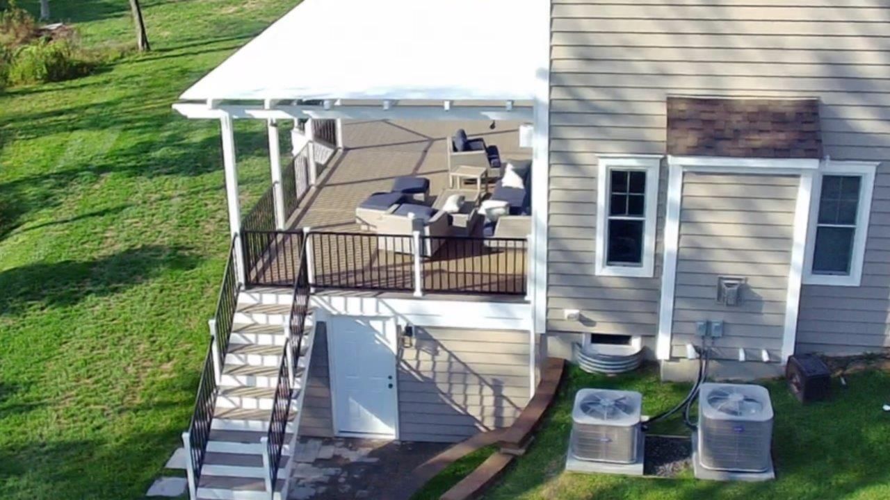 An aerial view of a house with a porch and stairs.