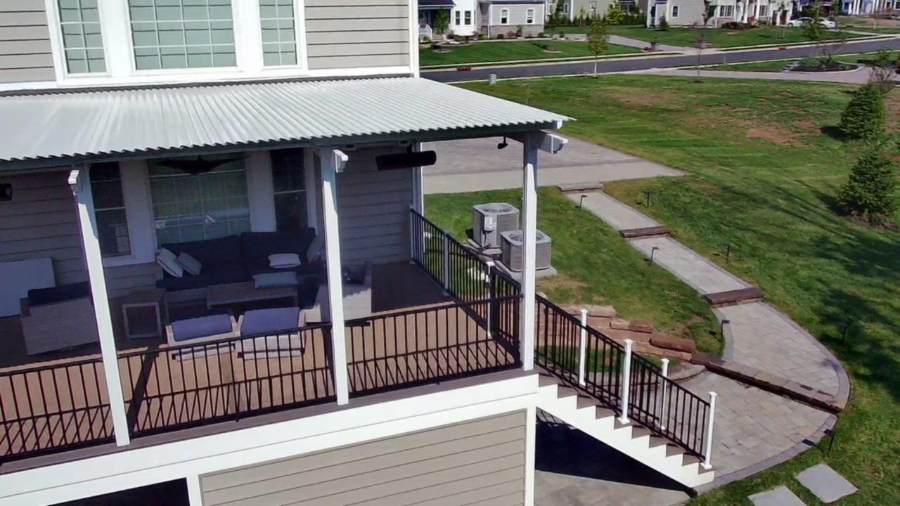 An aerial view of a house with a balcony and stairs.
