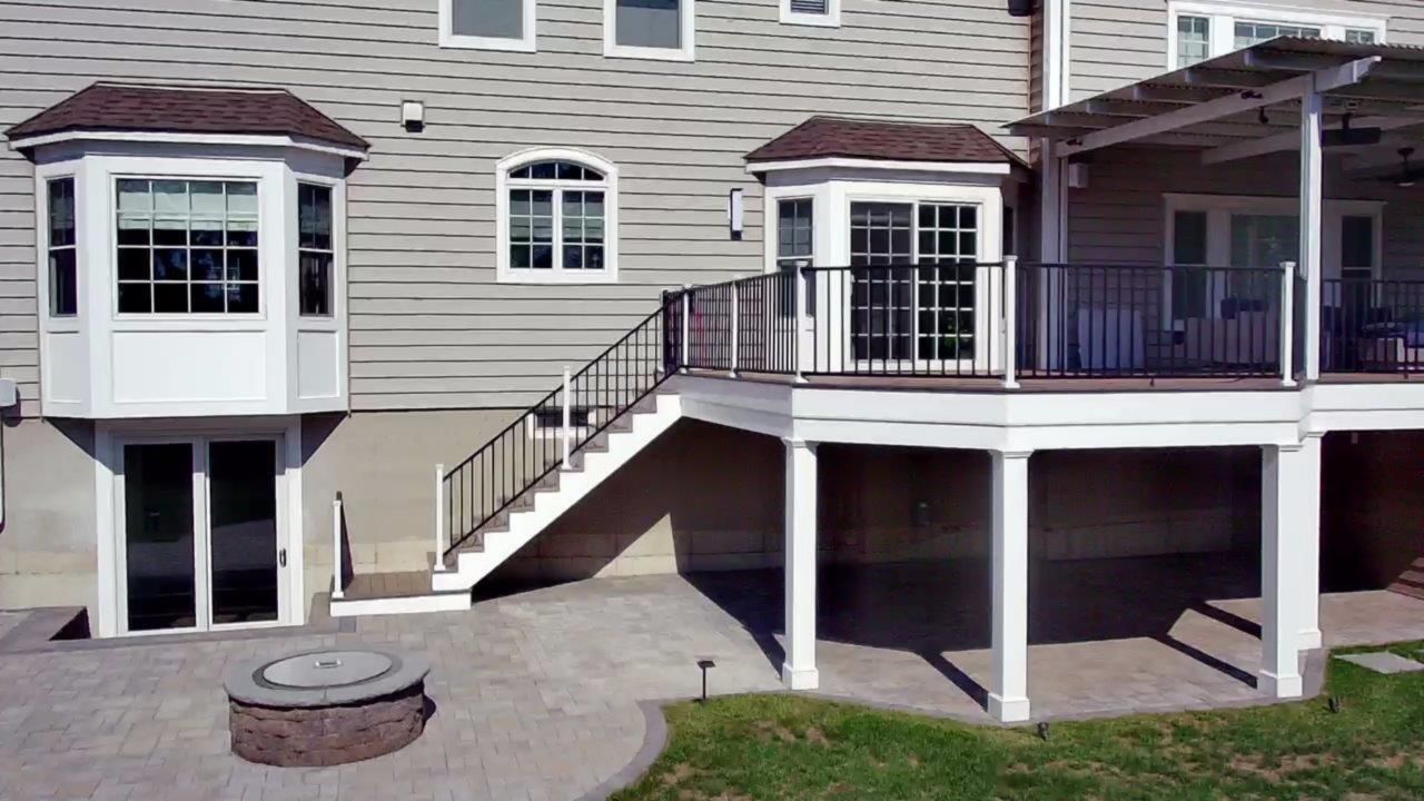 A house with a deck and stairs leading up to it