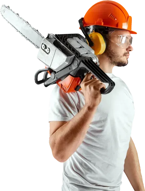 Man with chainsaw on shoulder, wearing hard hat, safety glasses, and ear protection.