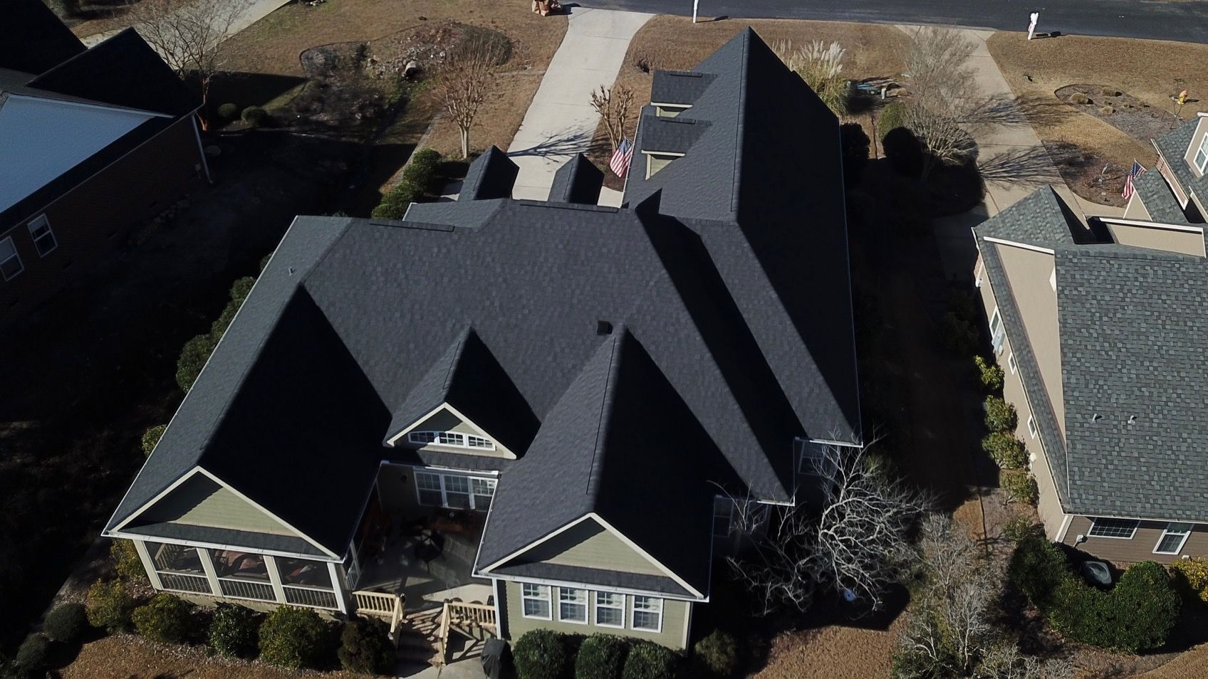 An aerial view of a house with a black roof