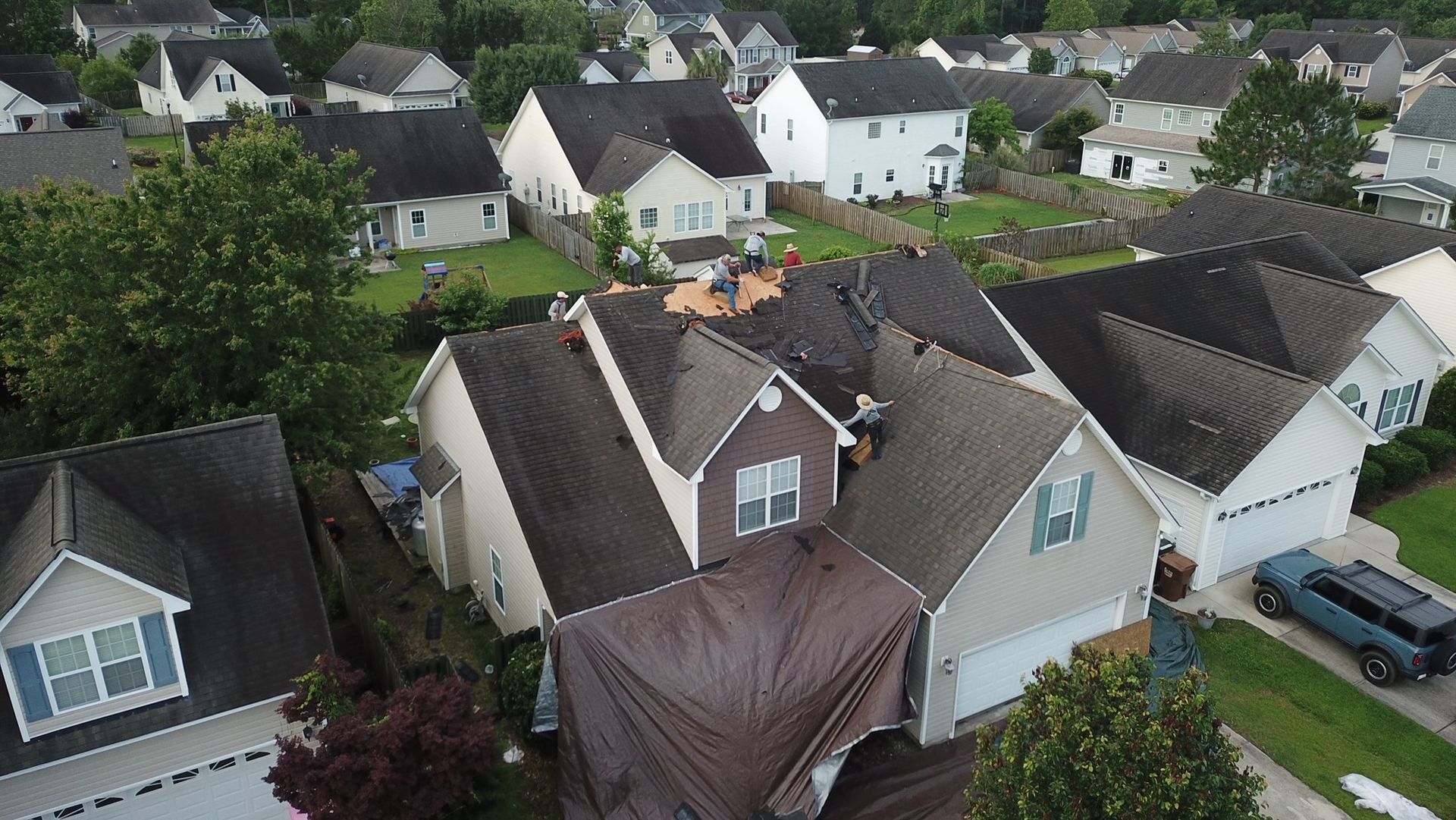 An aerial view of a residential neighborhood with houses and garages