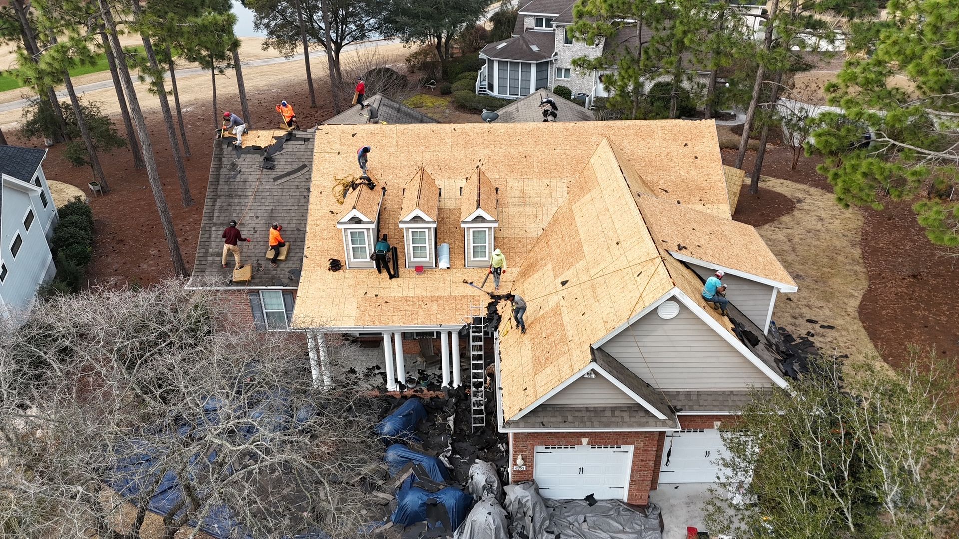 An aerial view of a house being remodeled with a new roof.