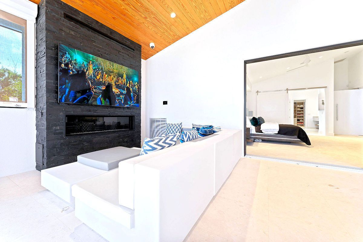 The Oasis Main House Living Areas include a living room with a couch , fireplace and television.