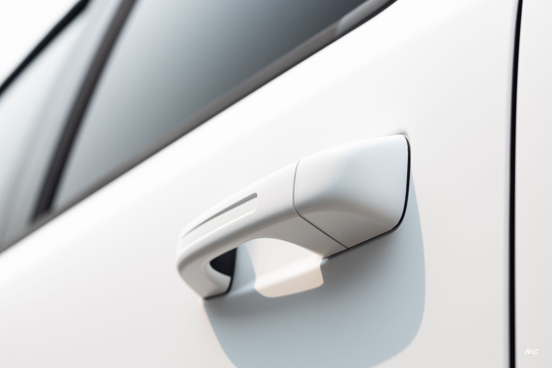 White car door handle close-up.