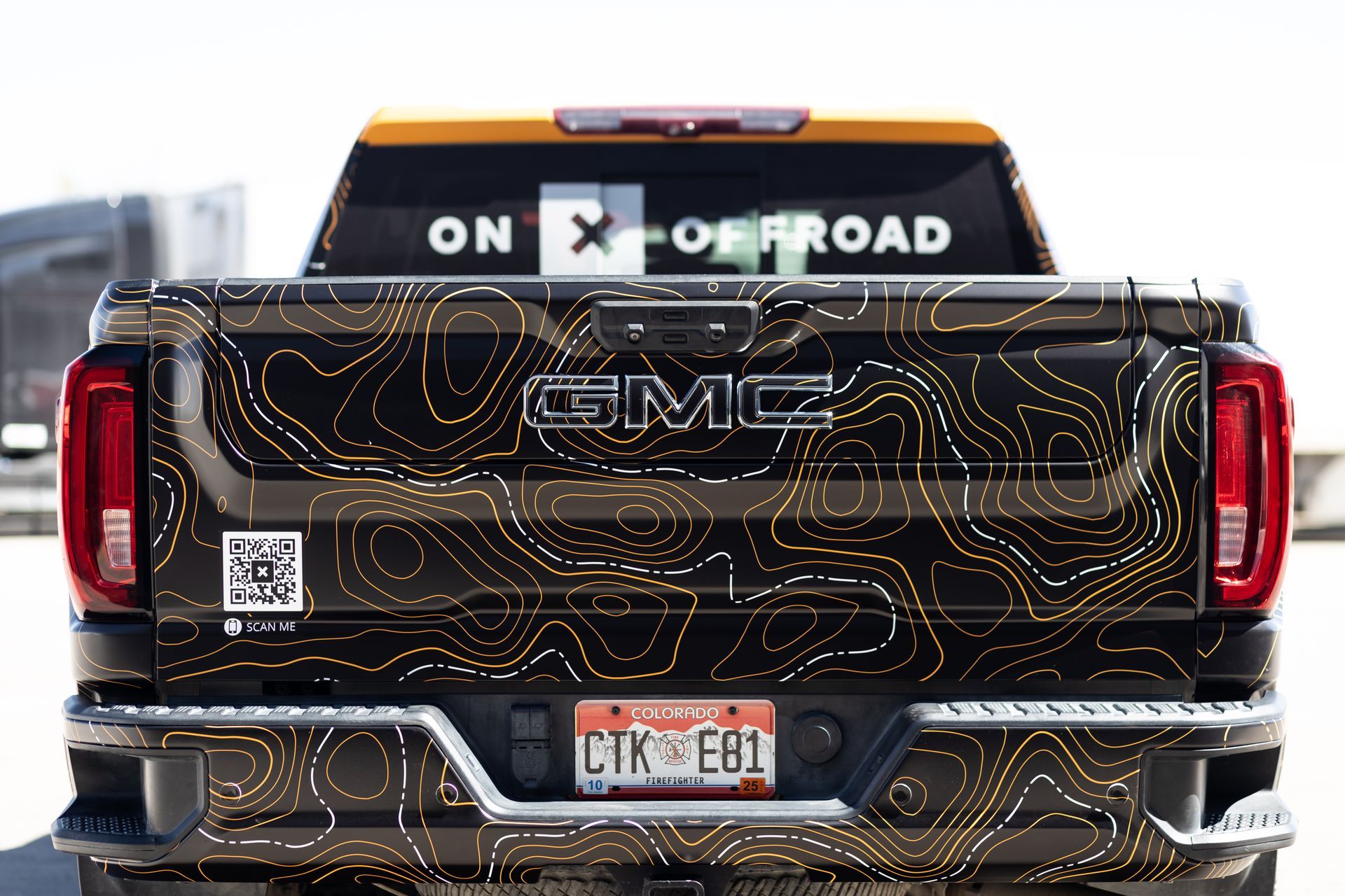 GMC truck rear with topography design on the truck bed.  
