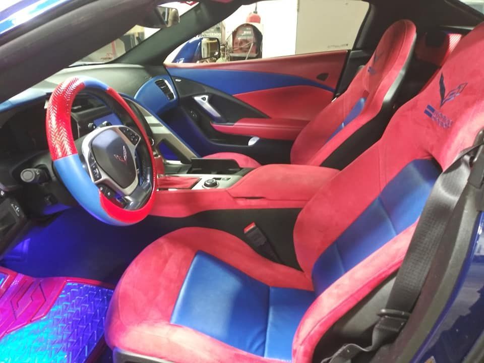 The interior of a car with red and blue seats