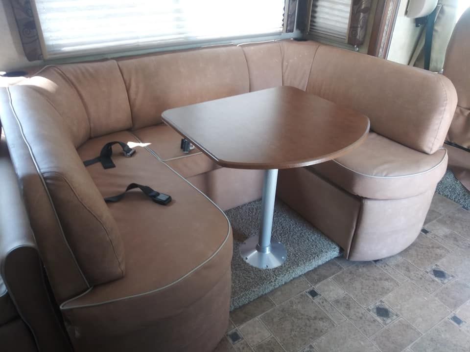 A couch with a table in the middle of it