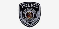 A black and white police patch on a white background.