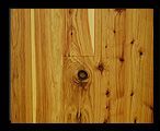 Wooden floorboards with varying wood grain and knots.