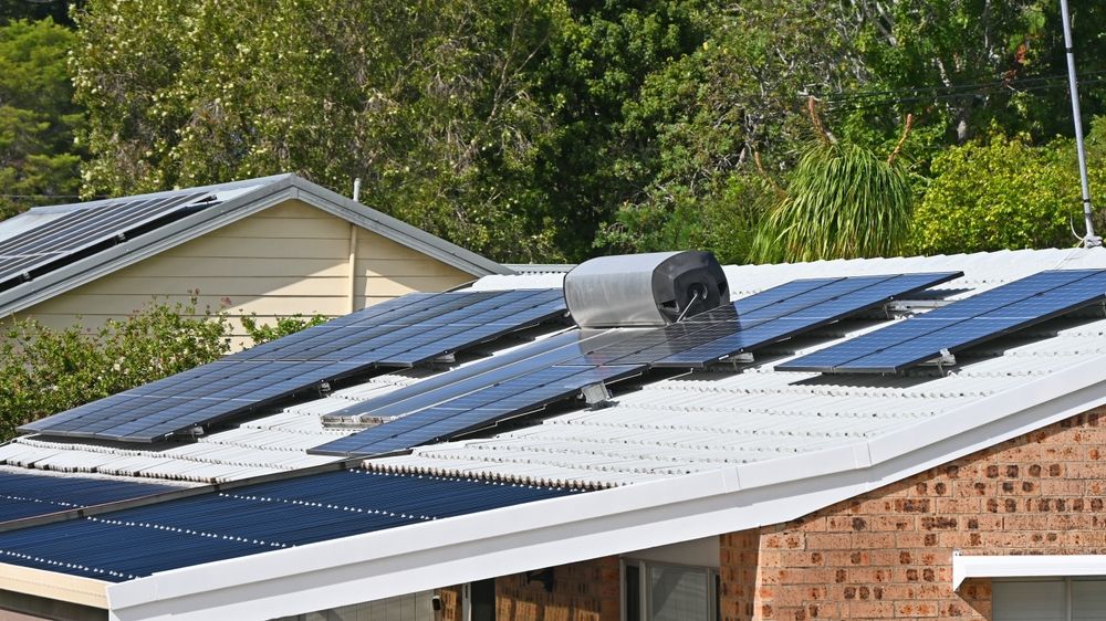 A row of solar panels on the roof of a house. — ASPLUM & CIVIL In Alice Springs, NT