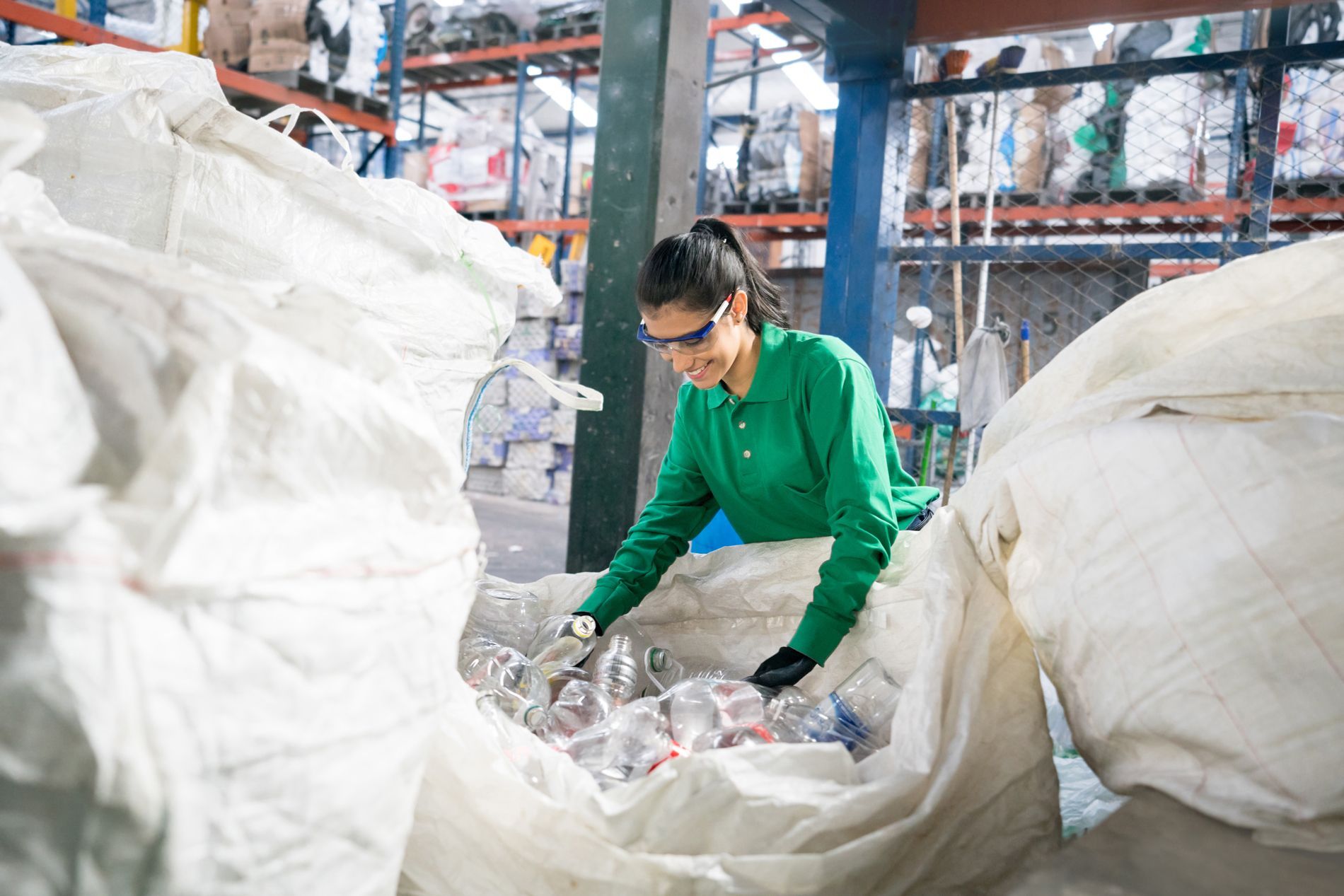Woman With Recyclable Bottles — Brewster, NY — Tri County Carting Sand Blasting & Welding Services