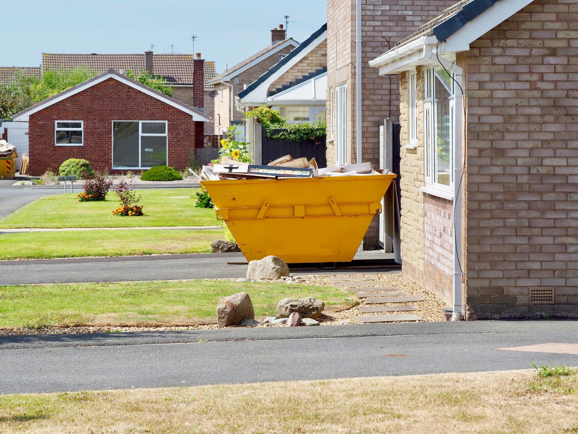 Dumpster Outside The House — Brewster, NY — Tri County Carting Sand Blasting & Welding Services