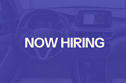 Purple-tinted car interior with bold white text reading “NOW HIRING”