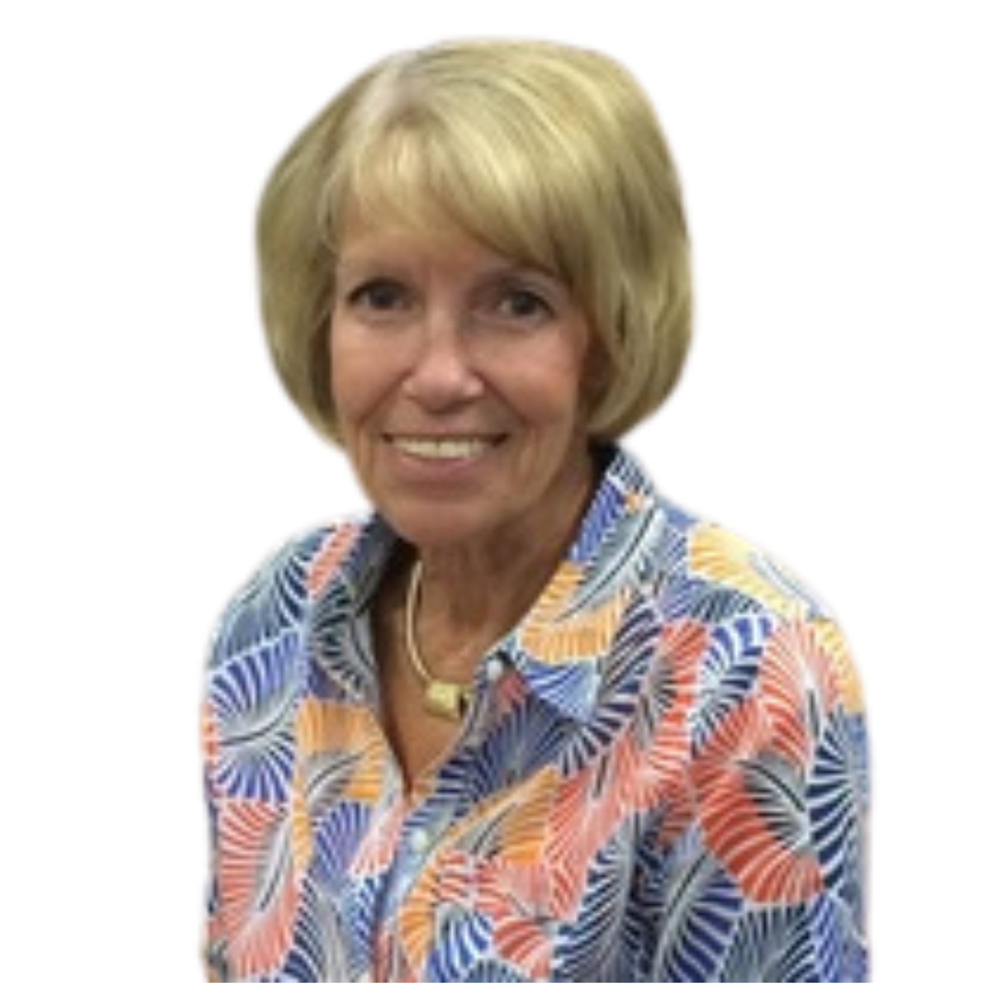 An older woman wearing a colorful shirt is smiling