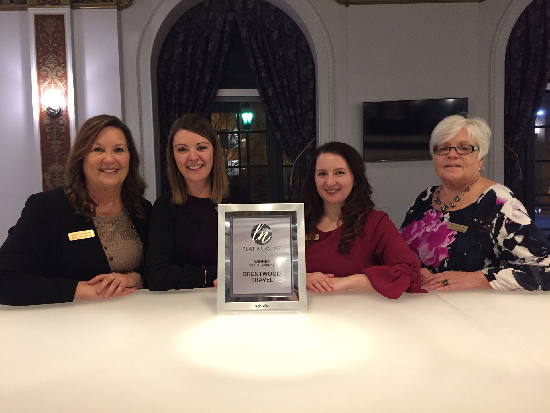 A group of women standing next to each other holding a certificate.