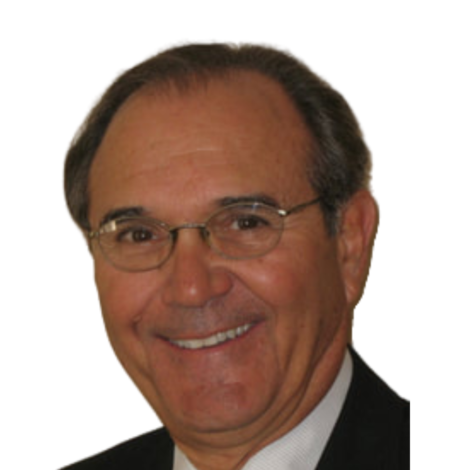 A man wearing glasses and a suit is smiling with a picture of a boat and two children behind him