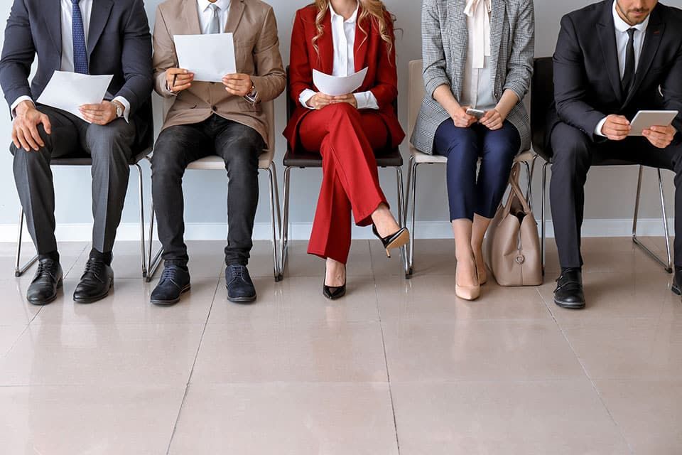 A group of people are sitting in chairs waiting for a job interview | Elgin, IL | 'I' in Team Series By IA Business Advisors