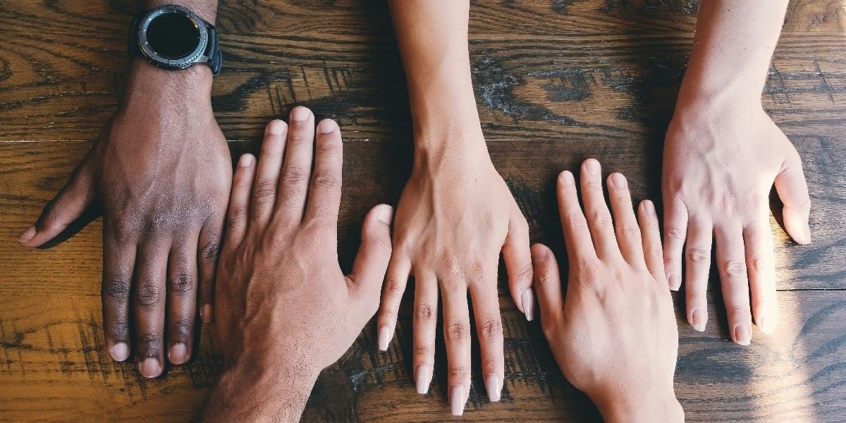 Hands Together on a Wooden Table | Elgin, IL | 'I' in Team Series By IA Business Advisors