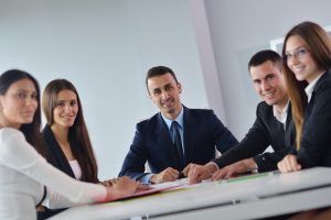 Group of people sitting and smiling | Elgin, IL | 'I' in Team Series By IA Business Advisors