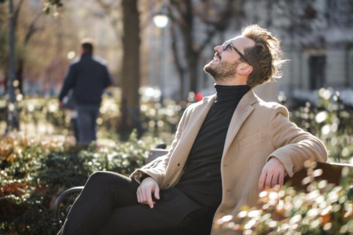 Man sitting on bench and looking up to sky | Elgin, IL | 'I' in Team Series By IA Business Advisors