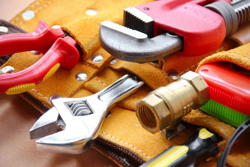 A Tool Belt Filled With Tools Including a Wrench and Pliers — Accredited Plumbing in Ulladulla, NSW