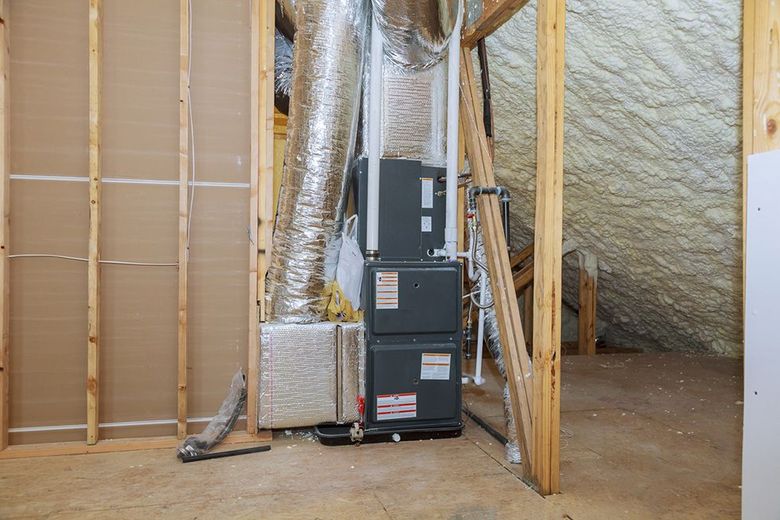 There is a furnace in the attic of a house under construction.