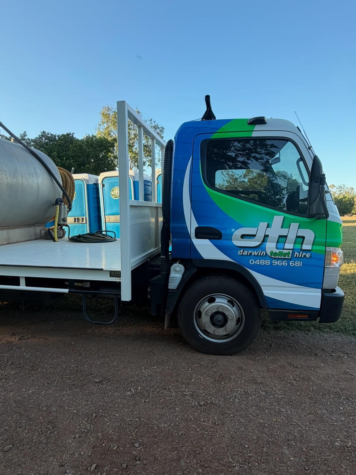 Blue and Green Truck Parked Outdoors With a White Tank on the Back — Darwin Toilet Hire in Rosebery, NT