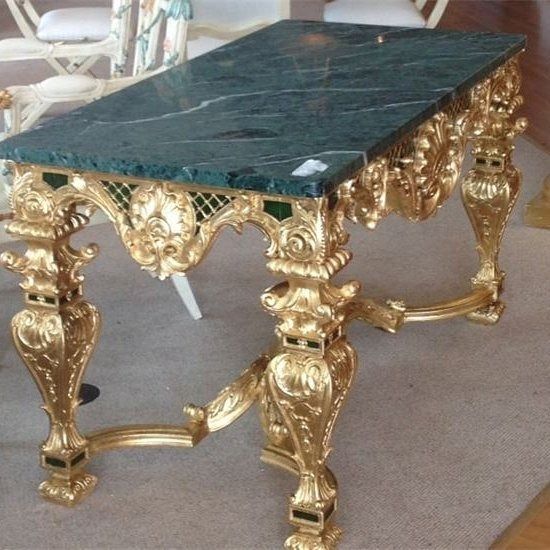 Ornate gold table with green marble top.