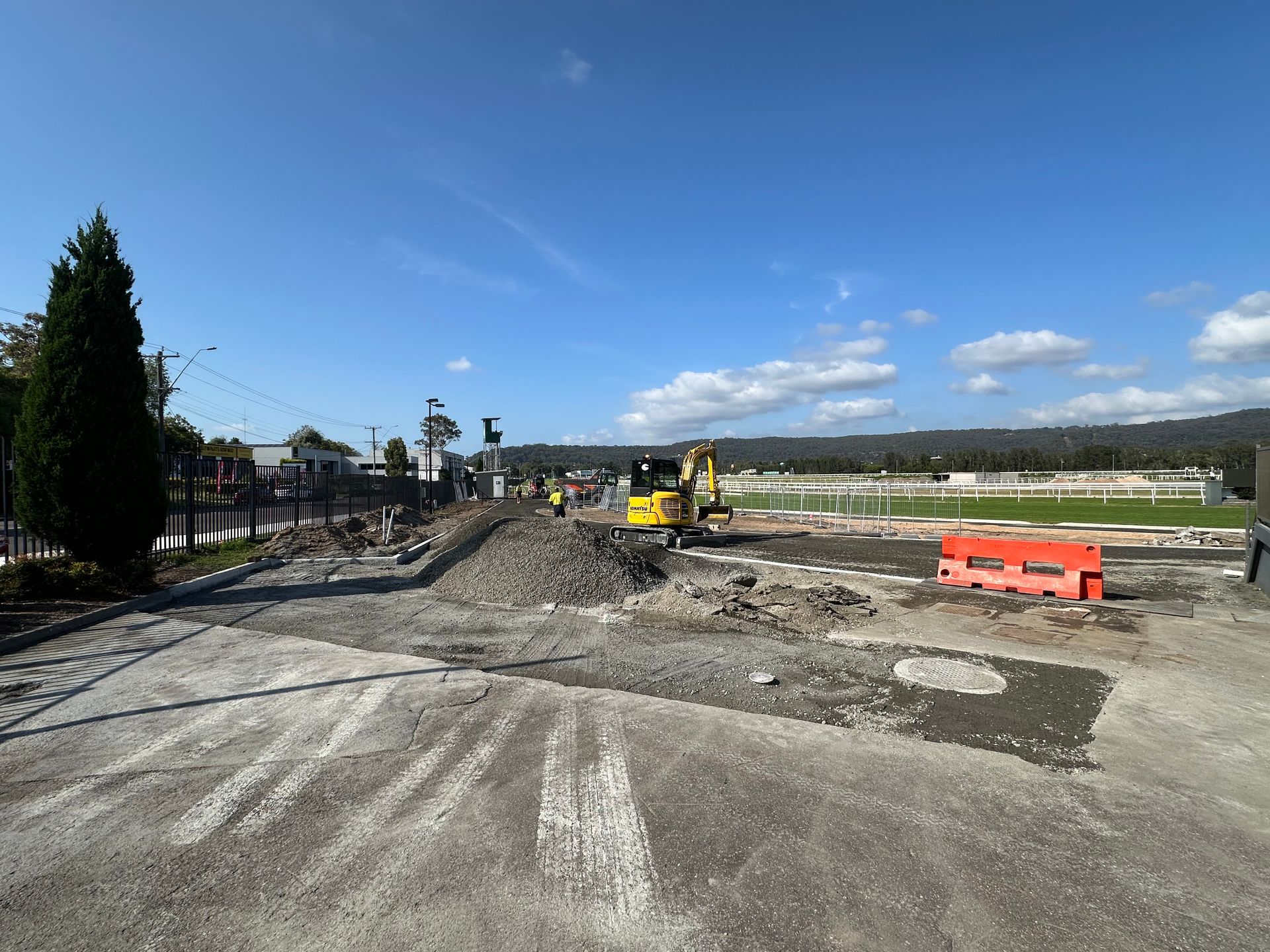 A construction site with a yellow excavator in the middle of it. — Adam Lowe Earthmoving Pty Ltd in Somersby, NSW