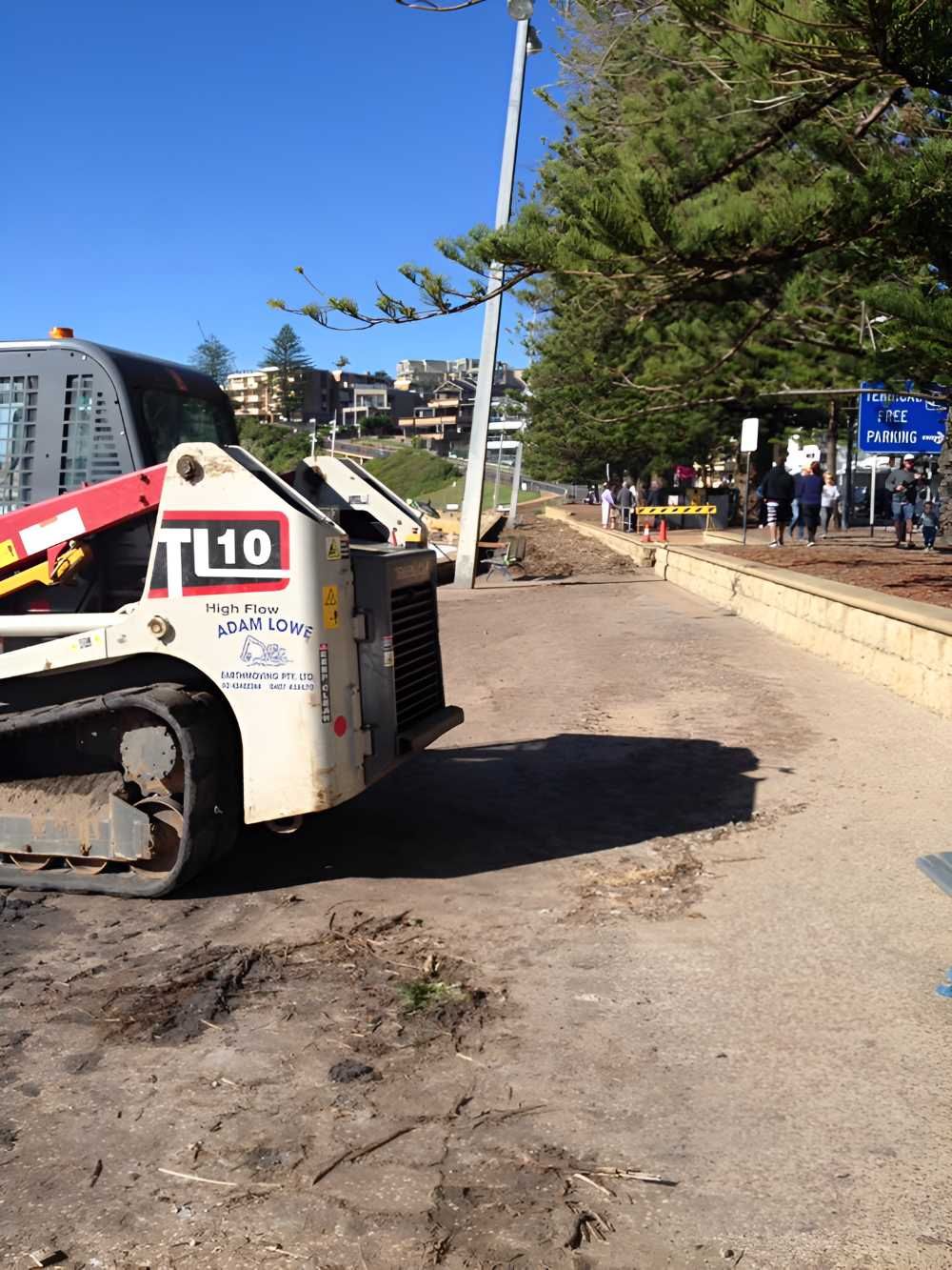 A Yellow Road Roller Is Parked in A Parking Lot — Adam Lowe Earthmoving Pty Ltd in Somersby, NSW
