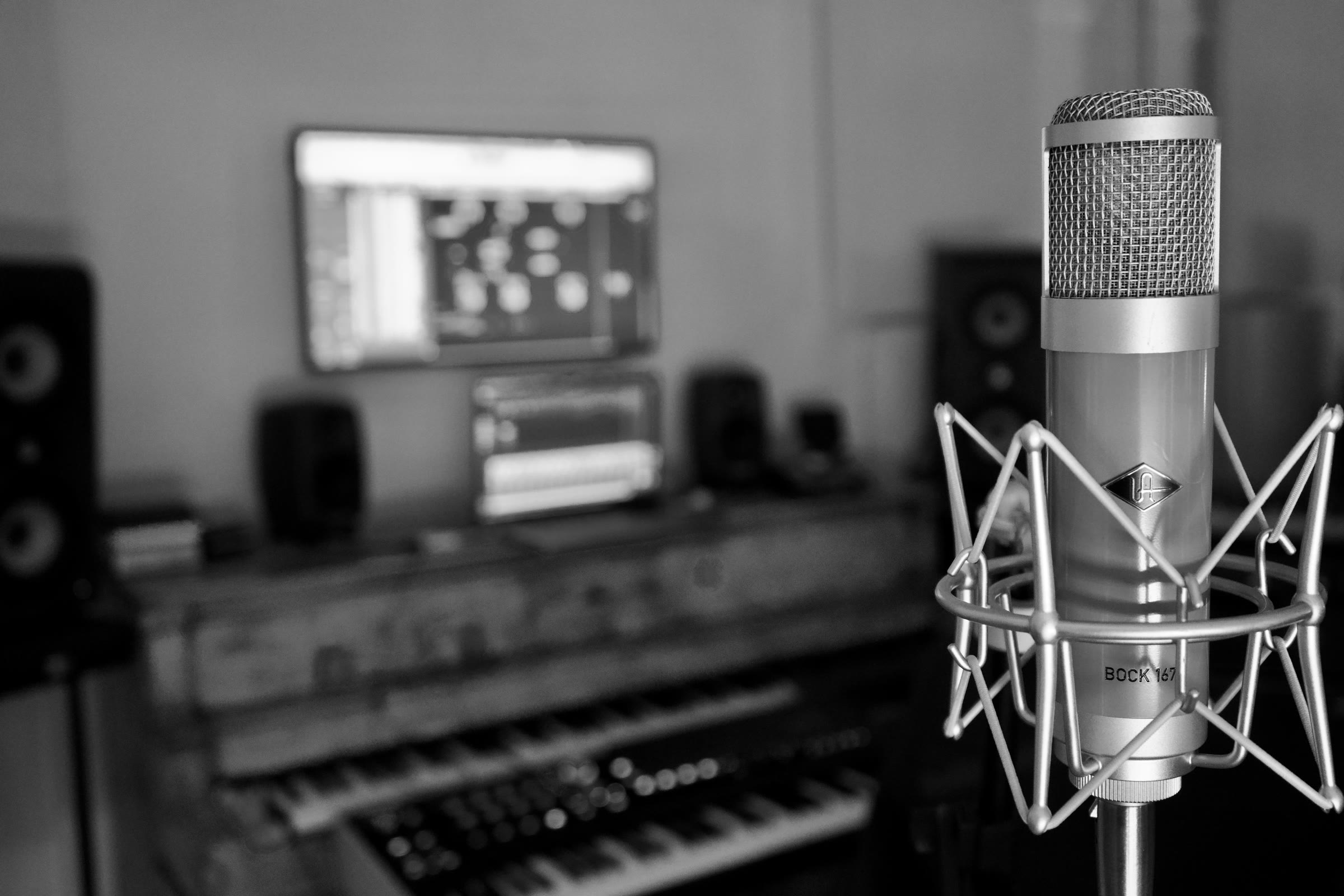 A studio microphone in front of recording equipment