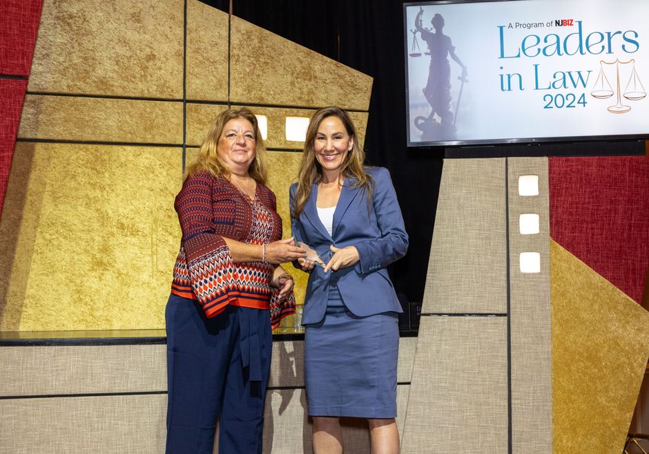 Two women are standing next to each other on a stage.