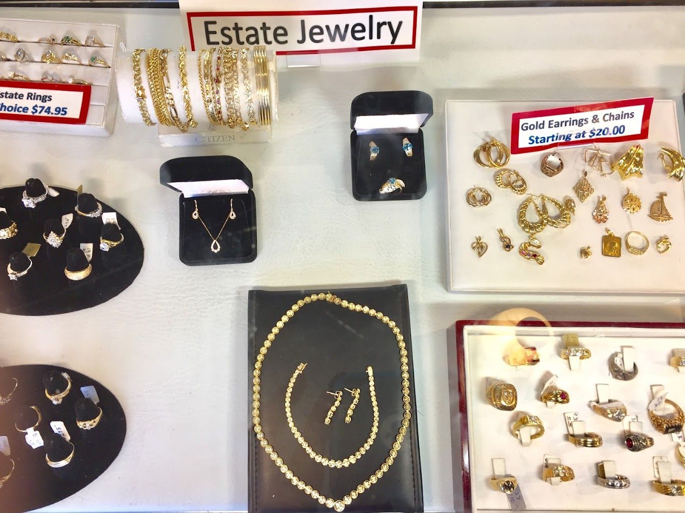 a display of estate jewelry including necklaces and rings