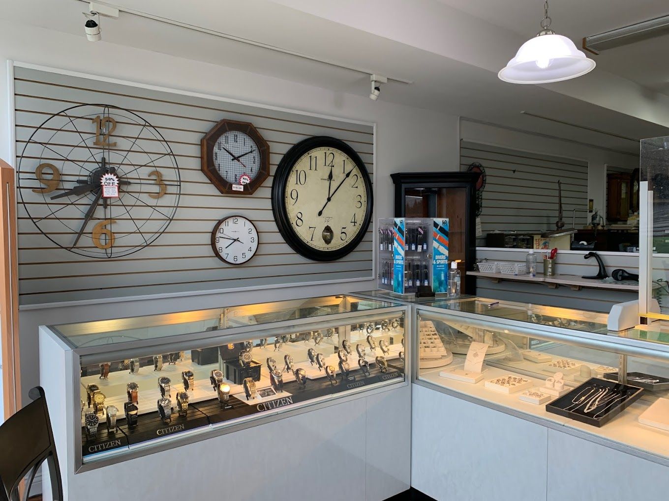 there are many clocks on the wall in this store .