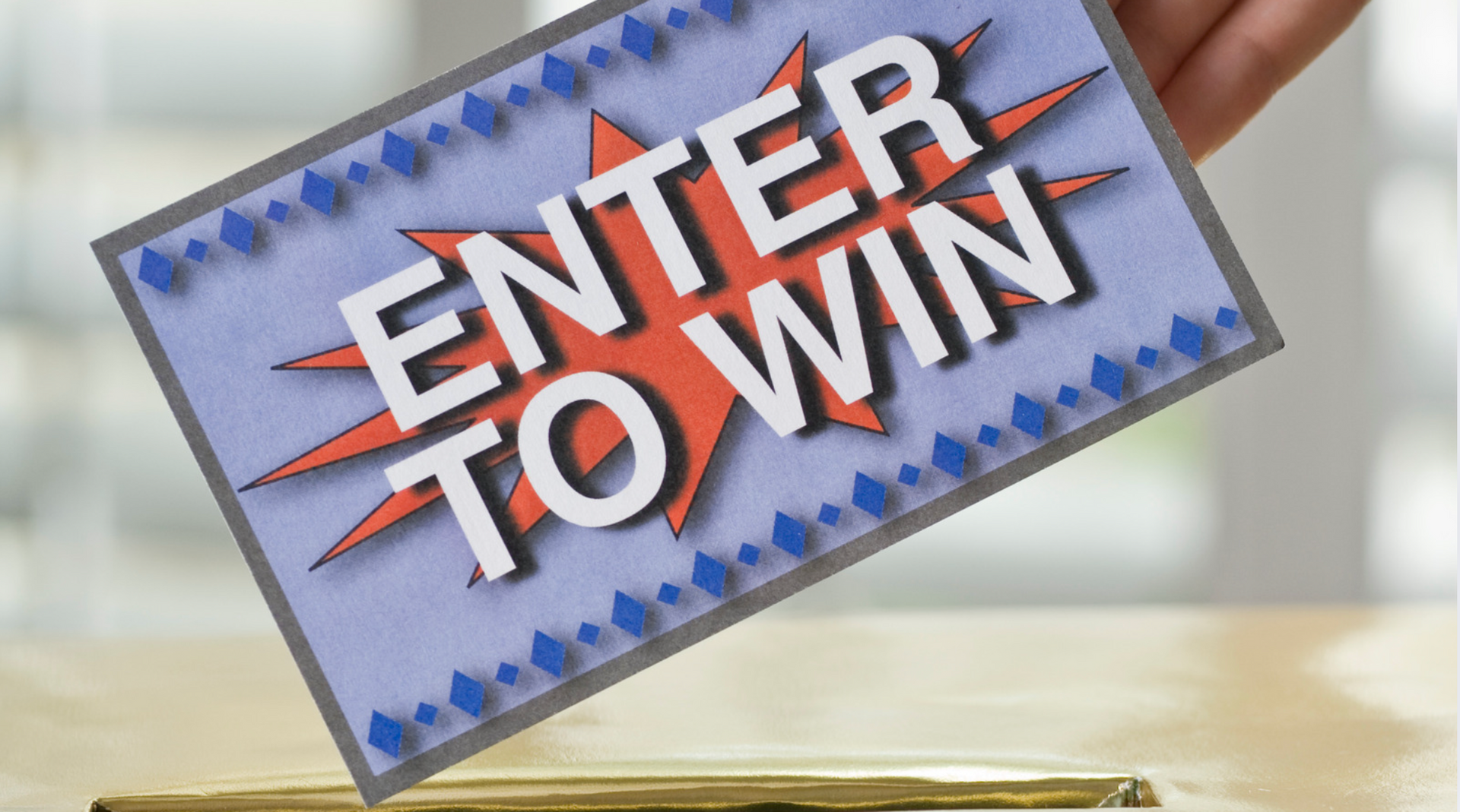A person is holding a card that says enter to win