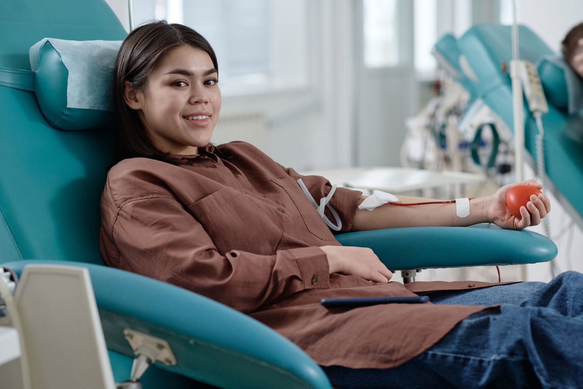 Woman in a chair receiving cancer treatment